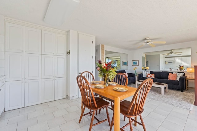 tiled dining area featuring a textured ceiling