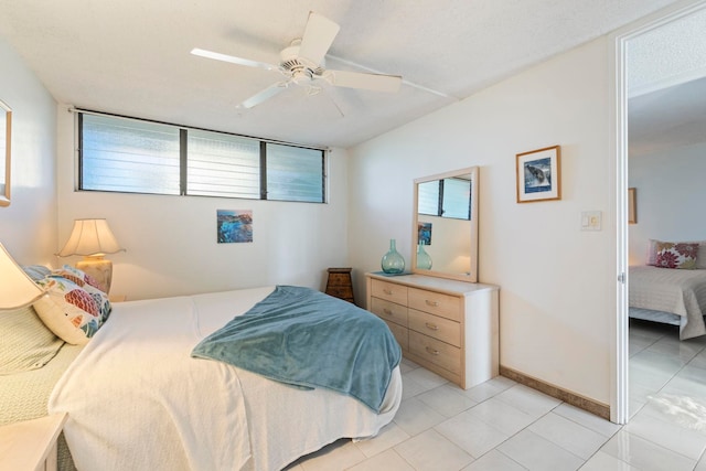 tiled bedroom featuring ceiling fan