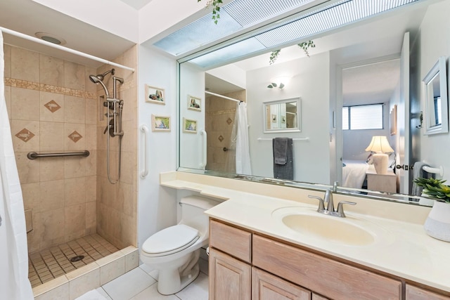 bathroom featuring toilet, vanity, a shower with curtain, and tile patterned floors