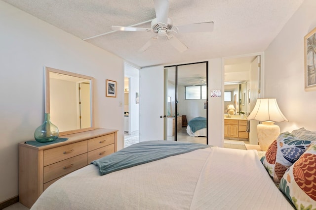 bedroom with ceiling fan, a textured ceiling, a closet, and ensuite bath