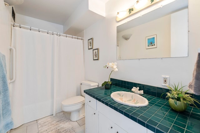 bathroom featuring toilet, vanity, and tile patterned floors