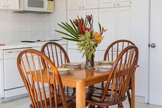 dining space featuring light tile patterned floors