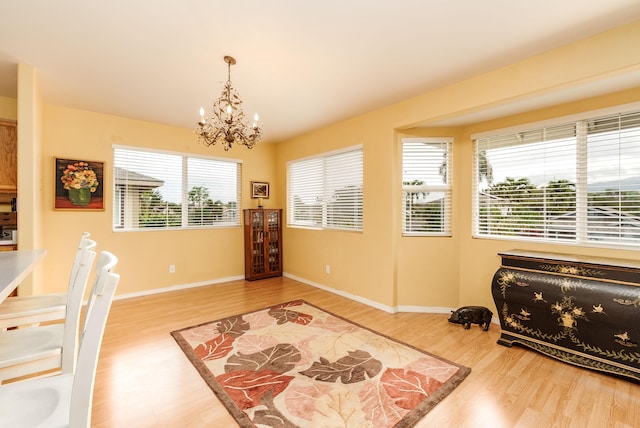 home office with a notable chandelier and hardwood / wood-style floors