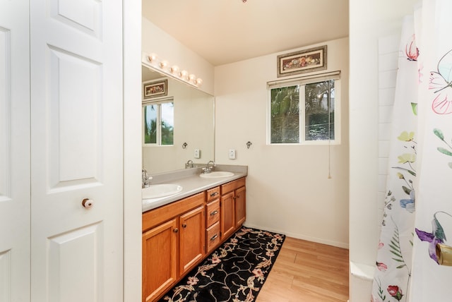 bathroom featuring vanity, curtained shower, and hardwood / wood-style flooring