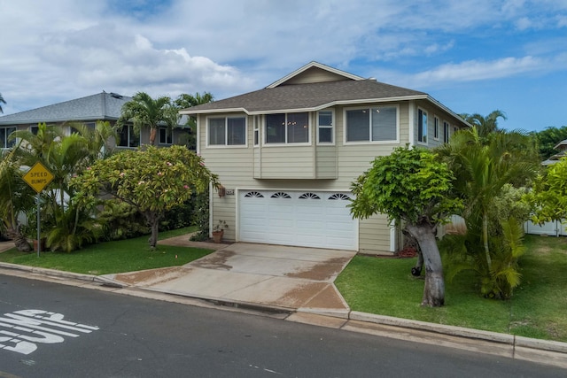 view of front facade featuring a front yard and a garage