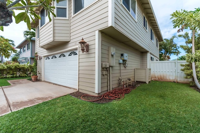 view of property exterior featuring a lawn and a garage