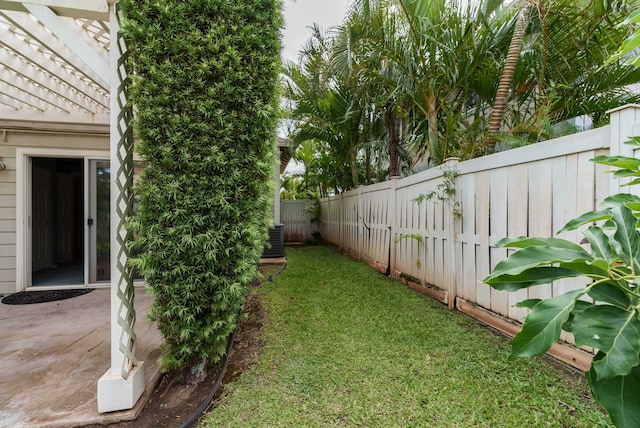 view of yard with a patio and central air condition unit