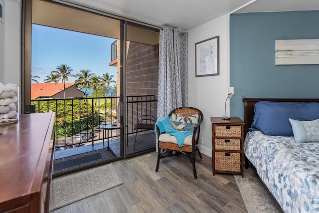 bedroom featuring hardwood / wood-style floors and access to outside