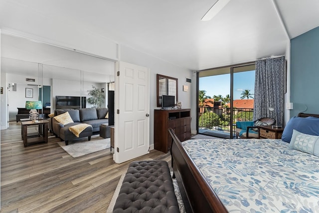 bedroom featuring ceiling fan, hardwood / wood-style flooring, and access to outside