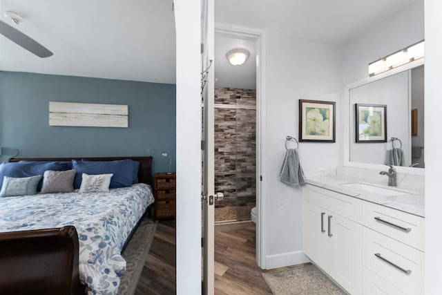 bedroom with sink, hardwood / wood-style floors, and ceiling fan