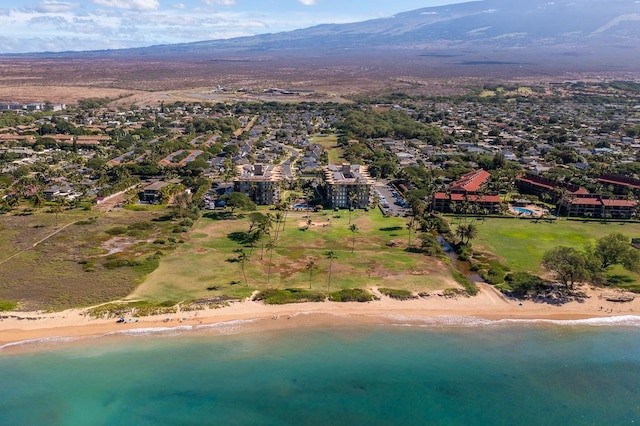 drone / aerial view featuring a beach view and a water and mountain view