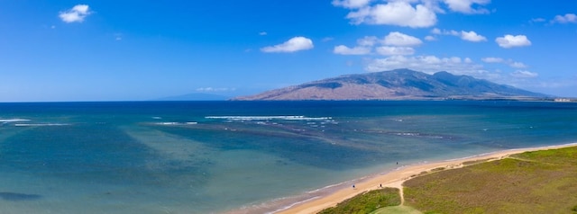 view of water feature with a mountain view and a beach view