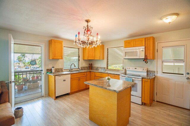 250 Kahiko St, Paia, HI 96779 - kitchen featuring white appliances, a sink, a chandelier, light wood-style flooring, and light stone counters