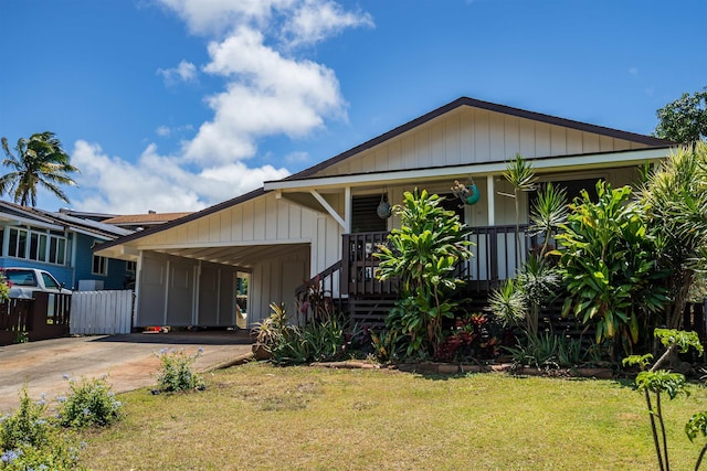250 Kahiko St, Paia, HI 96779 - view of front facade featuring a front lawn, driveway, an attached carport, and covered porch