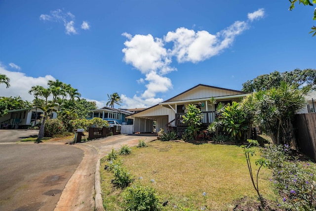 250 Kahiko St, Paia, HI 96779 - view of front of home featuring concrete driveway, covered porch, and a carport