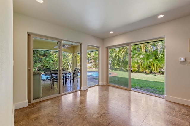 doorway featuring ceiling fan