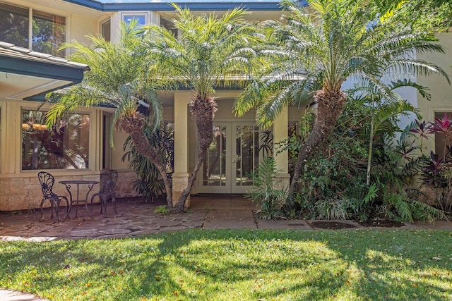 view of yard with french doors and a patio