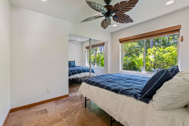 bedroom with ceiling fan and a closet