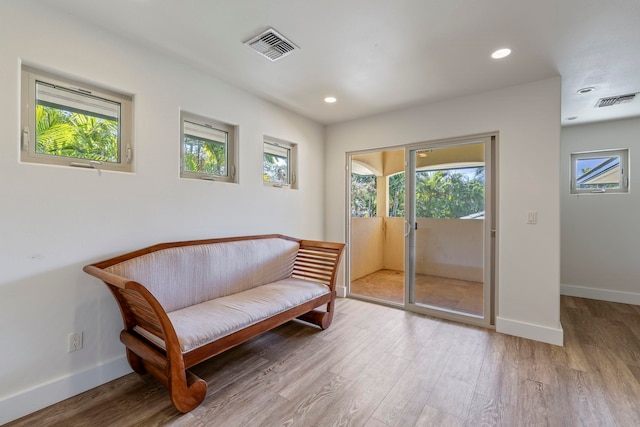 sitting room with wood-type flooring