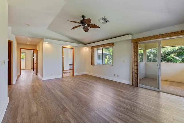 unfurnished room with ceiling fan, light hardwood / wood-style flooring, and lofted ceiling