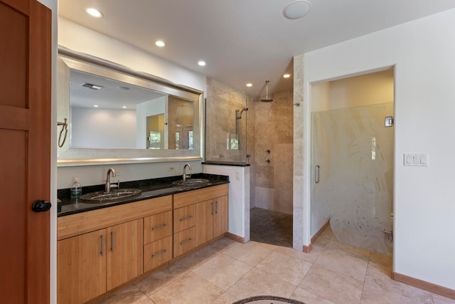 bathroom featuring tile patterned flooring, vanity, and an enclosed shower