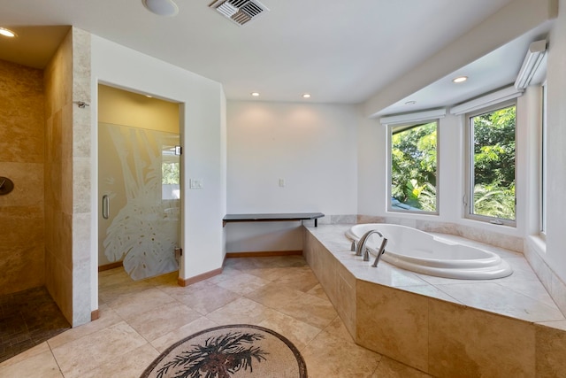 bathroom featuring independent shower and bath and tile patterned flooring