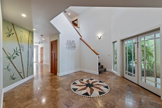 entrance foyer featuring a towering ceiling