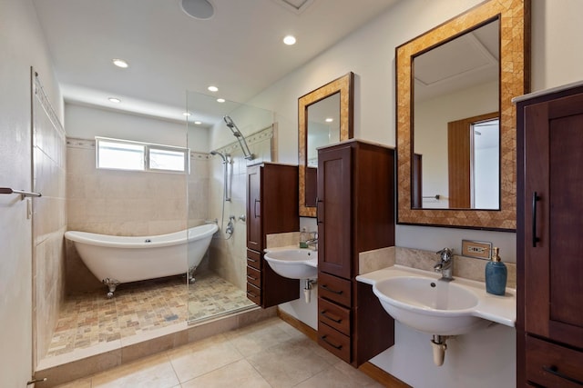 bathroom with tile patterned flooring, independent shower and bath, and sink