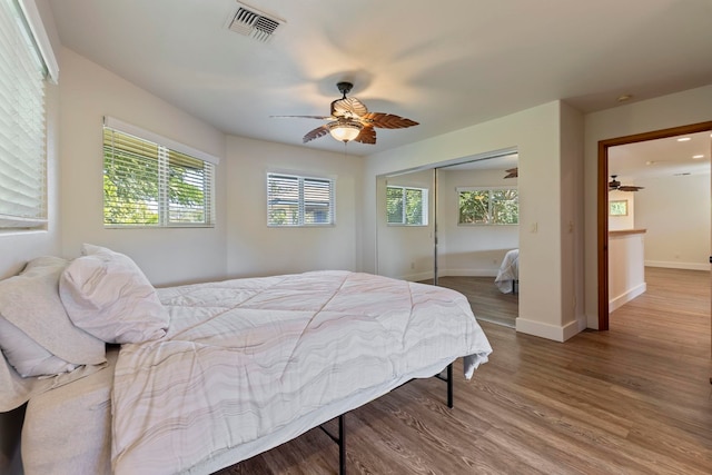 bedroom featuring ceiling fan, a closet, and wood-type flooring