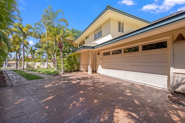 exterior space with a garage and a yard