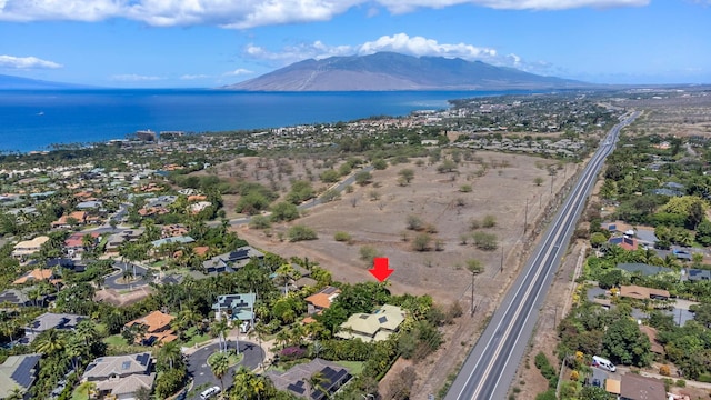 aerial view featuring a water and mountain view