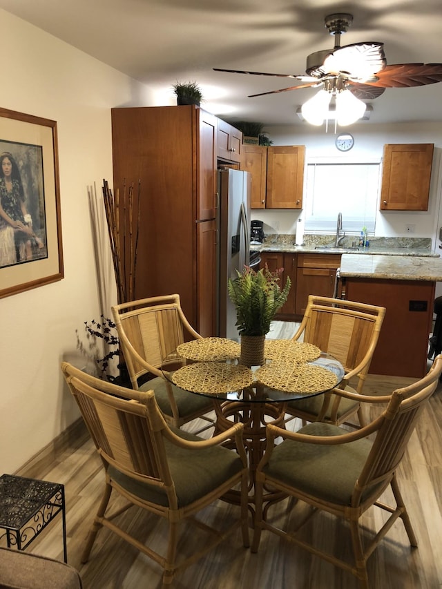 kitchen with ceiling fan, sink, stainless steel fridge with ice dispenser, and hardwood / wood-style floors