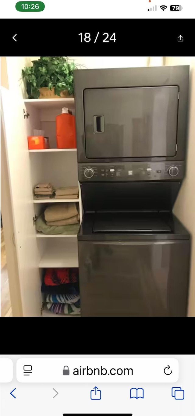 washroom featuring stacked washer and dryer