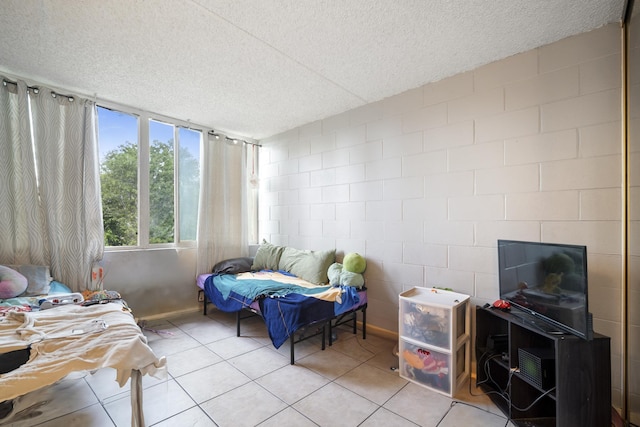 bedroom featuring light tile patterned floors and a textured ceiling