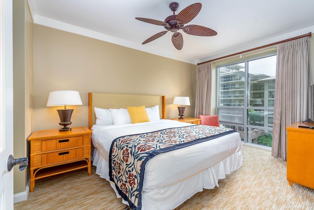 bedroom featuring multiple windows, ceiling fan, and ornamental molding