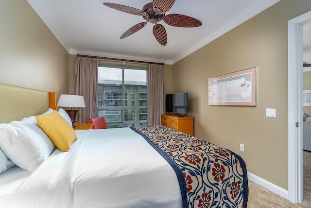 bedroom featuring ceiling fan, ornamental molding, and light hardwood / wood-style flooring