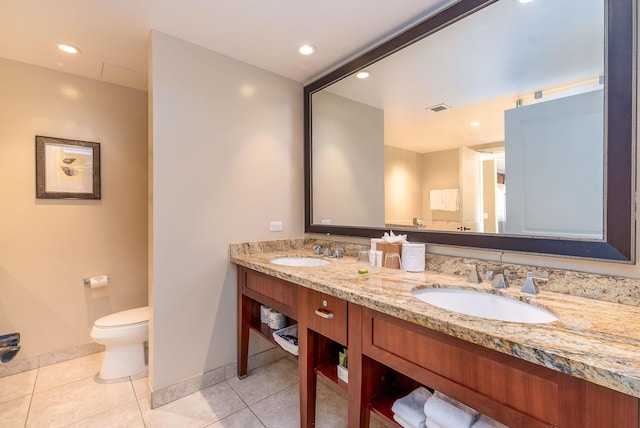 bathroom featuring tile patterned floors, vanity, and toilet