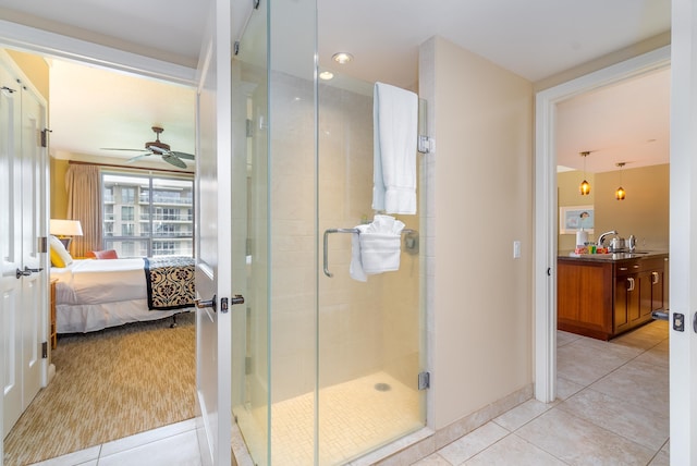 bathroom featuring ceiling fan, tile patterned flooring, a shower with shower door, and sink