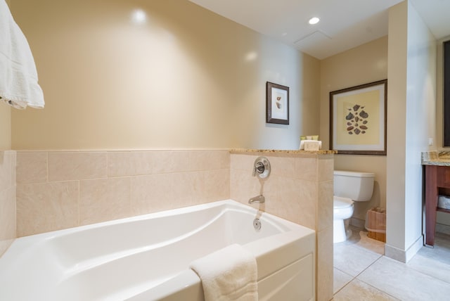 bathroom with tile patterned floors, a bathing tub, vanity, and toilet