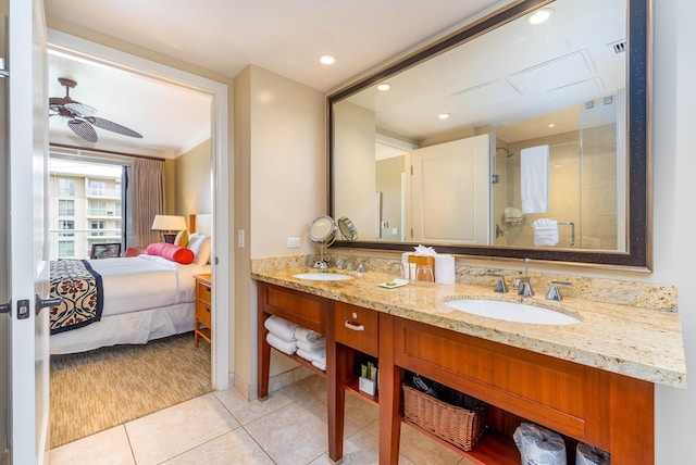 bathroom with ceiling fan, tile patterned flooring, vanity, and walk in shower