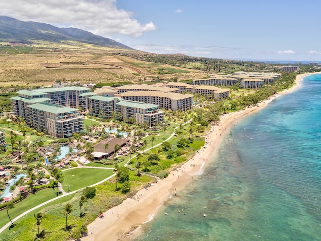 drone / aerial view featuring a beach view and a water and mountain view