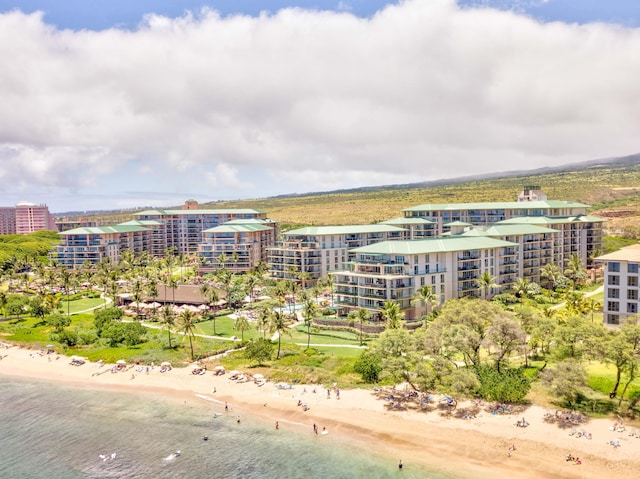 drone / aerial view with a water view and a beach view