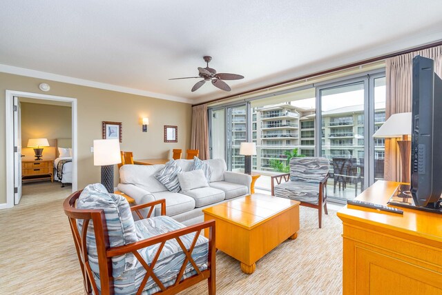 carpeted living room featuring crown molding, plenty of natural light, and ceiling fan