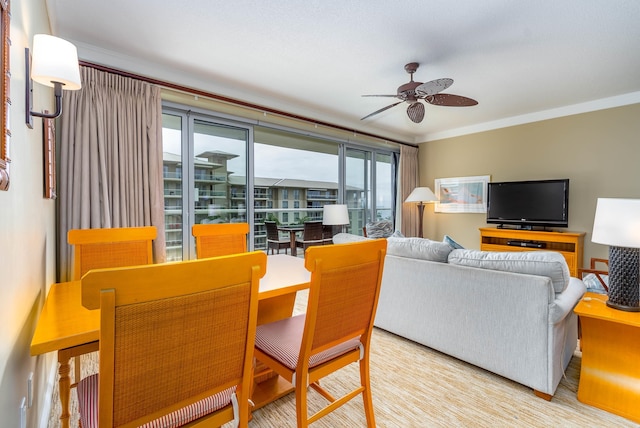 dining space with ceiling fan and ornamental molding