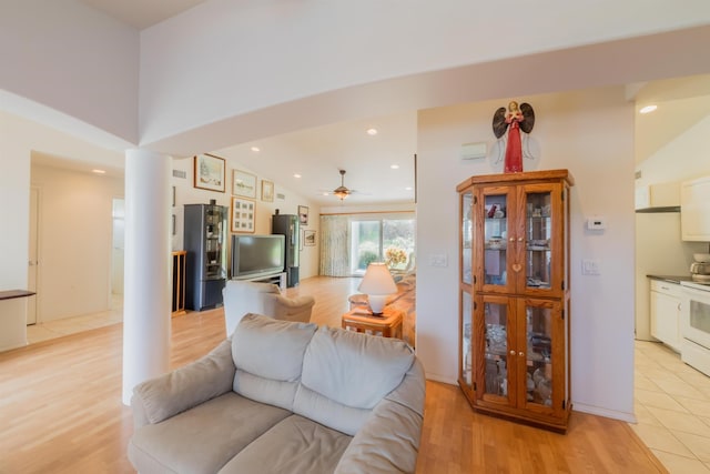 living room with a high ceiling and light wood-type flooring