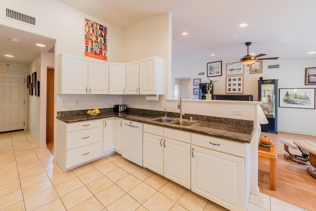 kitchen with white cabinets, kitchen peninsula, sink, and dishwasher