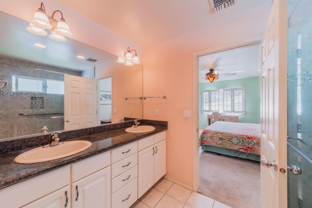 bathroom with tile patterned flooring, vanity, and walk in shower