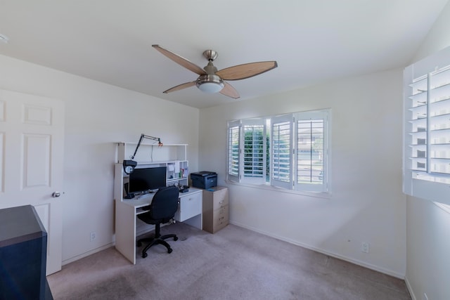 carpeted office space with ceiling fan