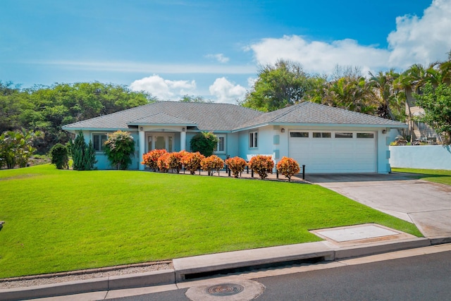 single story home with a garage and a front lawn