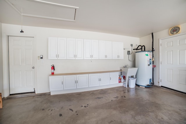 garage featuring sink and water heater